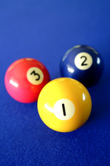 Three pool balls on blue