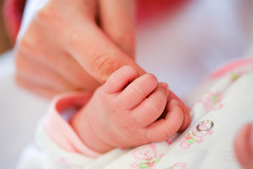 Mother holding her child's hand