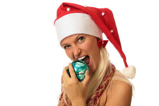 Young woman, like santa, eats christmas tree ornament
