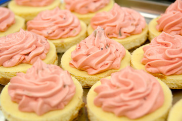 Cupkakes with pink cream dressing