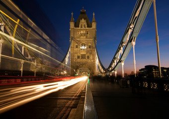 Tower Bridge with motion blur of passing double decker red bus