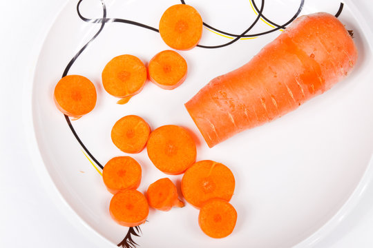 well-cut carrots on a white porcelain dish