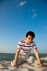 Fototapeta na wymiar young man by the beach