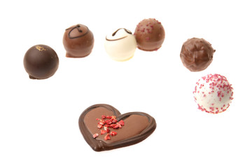 Heart shape chocolate with other chocolate around.