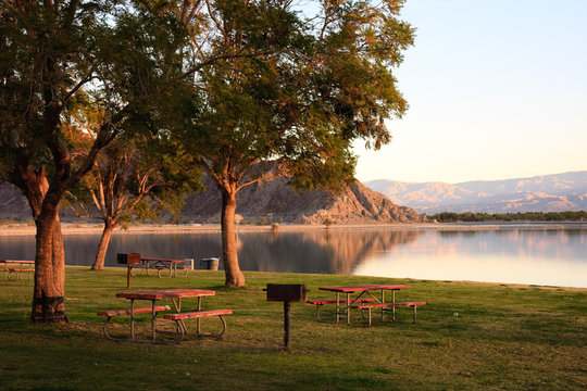 dawn at lake with bbq and picnic tables