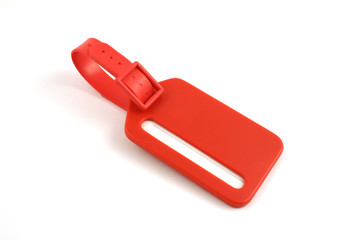 red plastic luggage label close up isolated