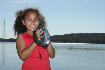 Girl with camcorder at the lake.