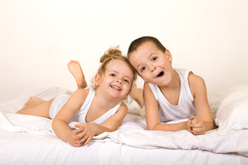 Kids having fun lazying in the bed