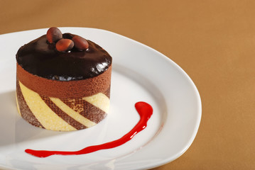 Chocolate Truffle cake with nuts and raspberry sauce