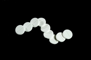 pills on a black background