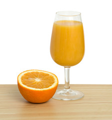 Goblet of natural orange juice and section of orange