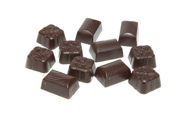 Delicious dark chocolate pralines isolated on white.