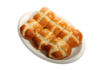 Easter hot cross buns stacked on a flat plate