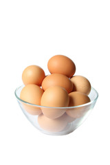 Colored eggs in glass bowl.