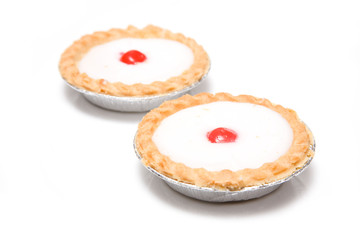 Bakewell tarts on a white background.