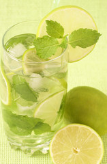 Mojito cocktail on green background
