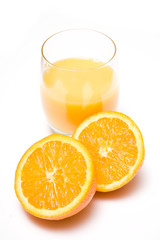 Glass of orange juice with a halved orange