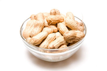 Bowl of monkey nuts on a white studio background.