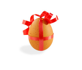 Egg with pink ribbon on white with clipping path.