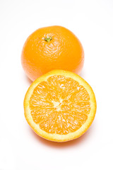 Oranges whole and halved on a white background.