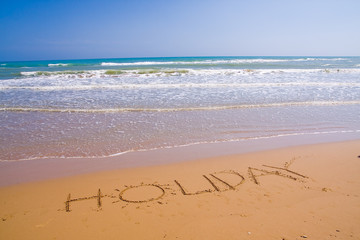 beautiful exotic beach in Mediterranean with a sign