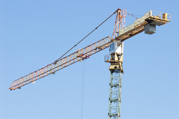 Building tower crane against blue sky