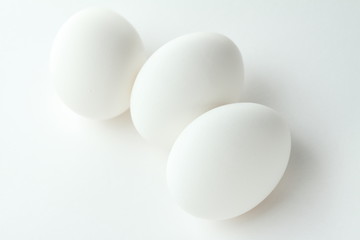 three eggs on white