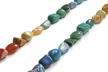 two rows of tumbled healing crystal stones