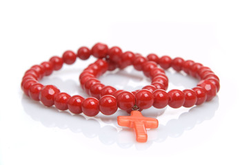 Red coral beads on a white background