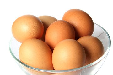 Colored eggs in glass bowl.