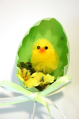 yellow toy easter chick hatching out of an egg shell