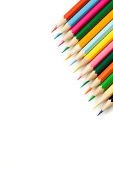 Many colour pencils on white background