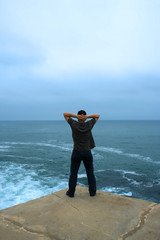 zen moment - man contemplating the ocean