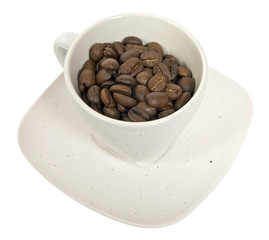 Cup with coffee beans isolated on white