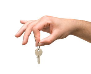 Close up of hand holding key isolated on background