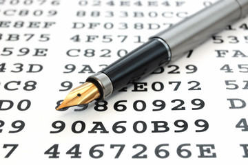 A gold-nibbed pen on a sheet with encrypted data
