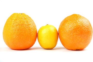 Two orange oranges and one yellow lemon