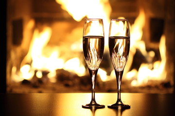 two glasses in front of fireplace
