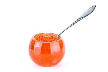 Glass bowl filled with red salmon caviar and small metal spoon