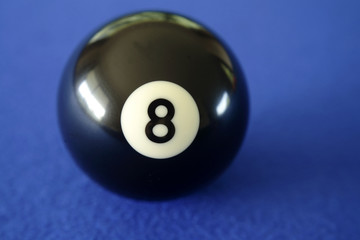 Number eight pool ball on blue background