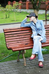Female sitting on a bench in park