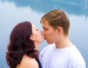 Fototapeta premium Loving couple kissing at water