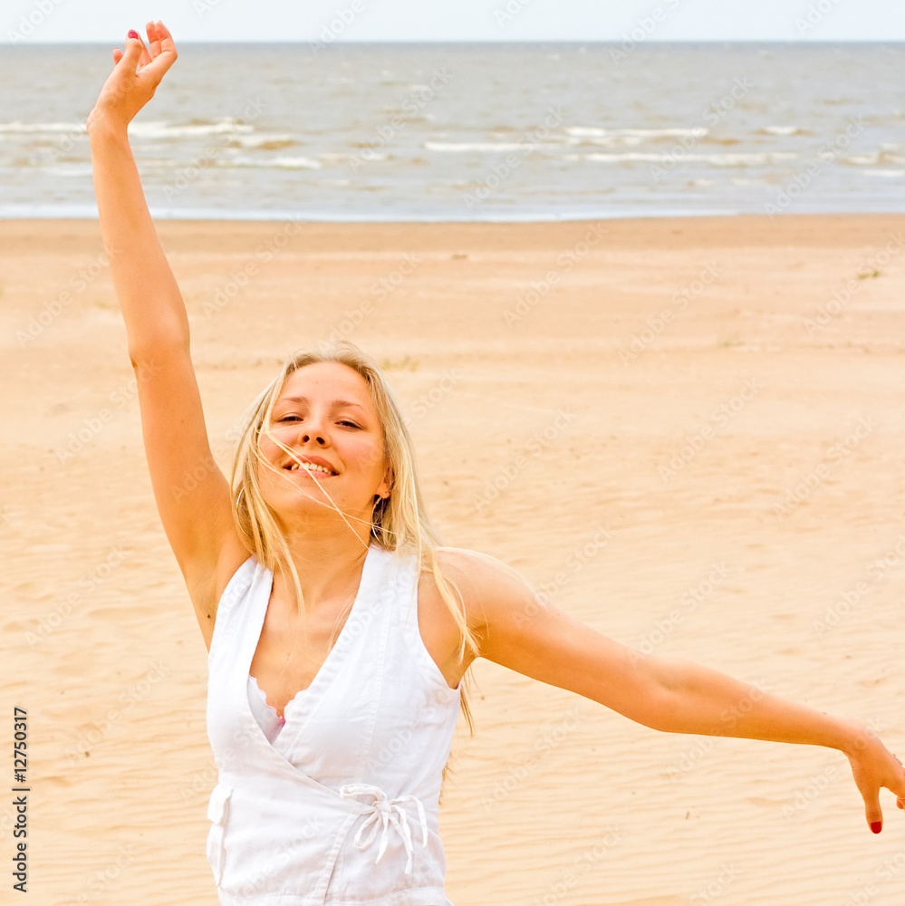 Poster woman exercising on a beach