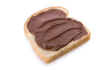 Hazelnut and chocolate spread over a slice of bread.