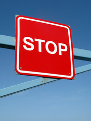 Close up of a red stop sign on a barrier.