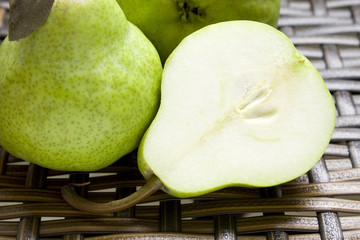 A Close-up of three juicy pears on a wicker background