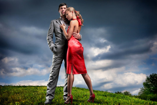 Young couple with storm cloudy sky
