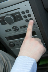 Mans hand and car radio