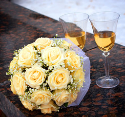 glasses of champagne and rose bouquet