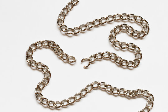 Nice torn chain with shadow lying on white background